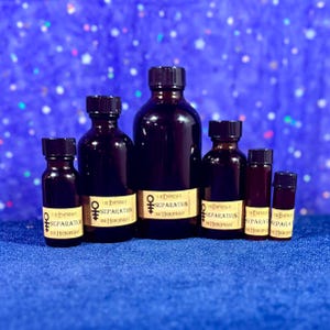May include: Six dark amber glass bottles of varying sizes, each with a black screw-top cap and a beige label. The labels feature the text "The Empress & Separation The Hierophant" along with a symbol resembling a cross with a circle on top.