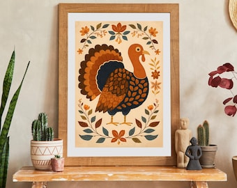 May include: Framed art print featuring a stylized turkey illustration. The turkey has a brown, orange, and blue color scheme, with a fanned tail and floral accents. The artwork is set against a cream background, framed in wood, and suitable for Thanksgiving decor.