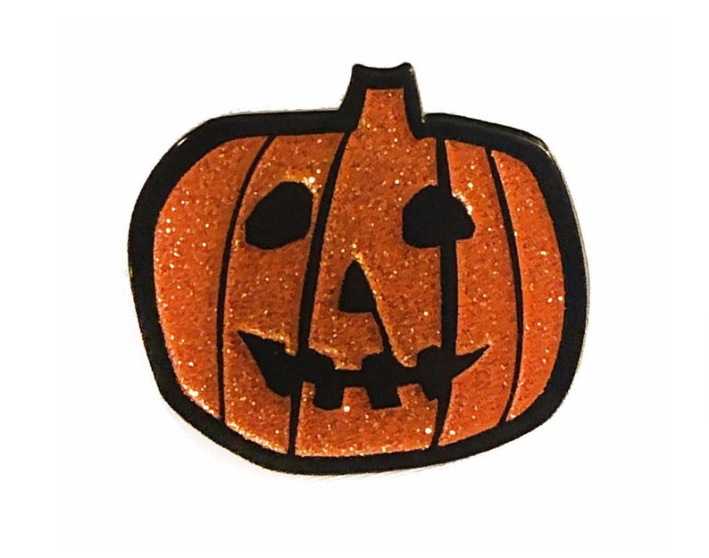 May include: Orange glitter pumpkin with a black jack-o'-lantern face.