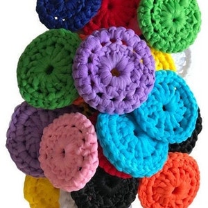 May include: A collection of colourful crocheted scrubbers in various colours, including blue, red, green, purple, pink, turquoise, yellow, black, and orange. The scrubbers are made of soft yarn and are perfect for cleaning dishes or other surfaces.