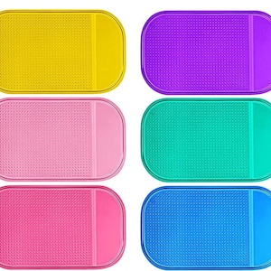 Puede incluir: Seis soportes para teléfono de silicona antideslizantes en diferentes colores: amarillo, rosa, verde, azul, morado y rosa claro. Cada soporte tiene una superficie texturizada y un borde elevado para evitar que tu teléfono se deslice.