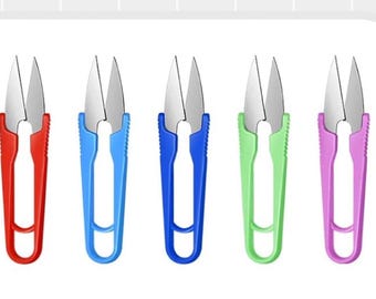 May include: Five thread snips in a row, each with a silver blade and a colored handle. The handles are red, blue, blue, green, and pink. These small scissors are used for cutting threads and yarns in sewing and crafting projects.