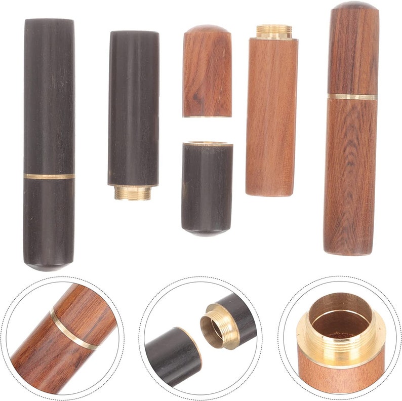 May include: Wooden toothpick holders in various stages of assembly. The holders are cylindrical, with a dark brown or light brown wood finish. Some have brass accents. The holders are shown both assembled and disassembled.