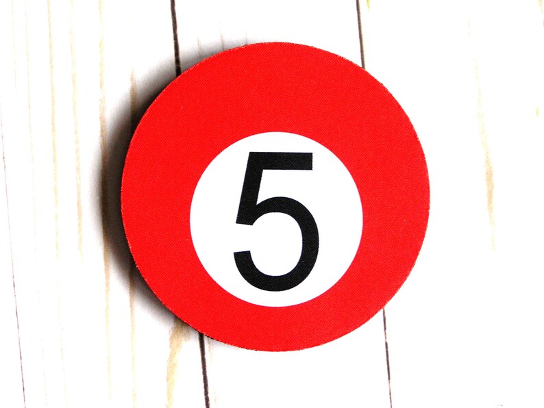 May include: A red circle with a white circle inside, containing the number 5 in black.