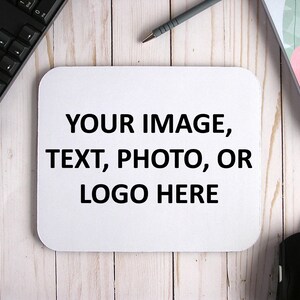 May include: White mouse pad with the text "YOUR IMAGE, TEXT, PHOTO, OR LOGO HERE" printed in black.