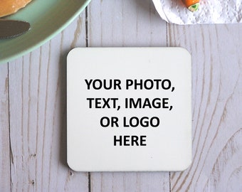 May include: White square coaster with the text "YOUR PHOTO, TEXT, IMAGE, OR LOGO HERE" printed in black.
