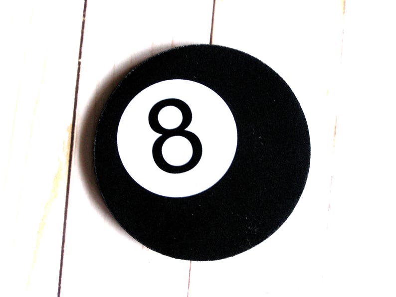 May include: A black and white 8-ball with a white number 8 on a black background.