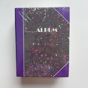 May include: A set of three ceramic mugs with a speckled, matte finish. The mugs are in shades of cream, light gray, and dark gray. Each mug has a simple, minimalist design, perfect for coffee or tea.