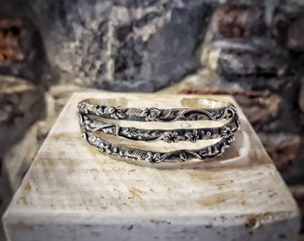 Silver floral rigid band bracelet, handcrafted open slave bracelet.