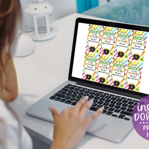 May include: A laptop screen displaying printable St. Patrick's Day gift tags with the text "So lucky to have you!" and a pot of gold. The text "instant download print at home!" is displayed below the laptop.