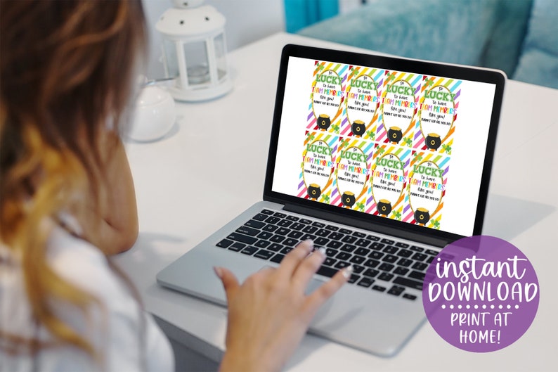 May include: A laptop screen displaying printable St. Patrick's Day gift tags with the text "So lucky to have you!" and a pot of gold. The text "instant download print at home!" is displayed below the laptop.