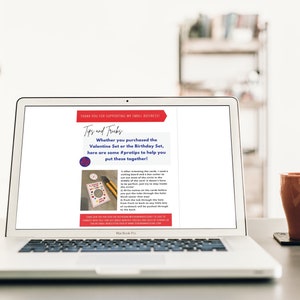 May include: A laptop screen displaying a webpage with the text "Tips and Tricks" and instructions on how to assemble a Valentine's Day or Birthday craft kit. The text says "Whether you purchased the Valentine Set or the Birthday Set, here are some #pratips to help you put these together!"