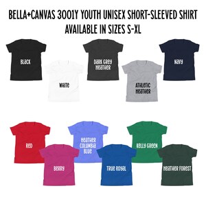 May include: A selection of youth unisex short-sleeved shirts in various colours, including black, white, red, berry, heather columbia blue, dark grey heather, true royal, athletic heather, kelly green, navy, and heather forest. The shirts are available in sizes S-XL.