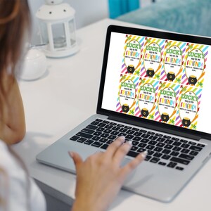 May include: A laptop screen displaying printable gift tags with a rainbow striped background and the text "So lucky you're my friend!" with a pot of gold and shamrock graphic.