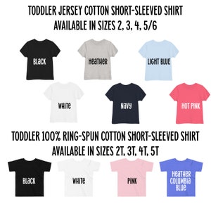 May include: A selection of toddler short-sleeved shirts in various colours, including black, white, heather grey, light blue, navy, hot pink, and a heather blue with the text "Heather Columbia Blue". The shirts are available in sizes 2, 3, 4, 5/6 and 2T, 3T, 4T, 5T.