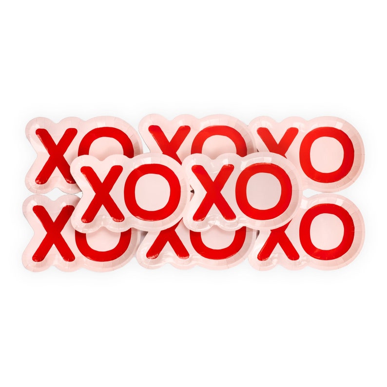 May include: A set of eight pink paper plates with red "XO" printed on them. The plates are stacked and overlapping.
