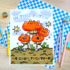 May include: A colorful illustration of four mushrooms with smiling faces. The mushrooms are orange and red with white spots. The text "In this patch we grow together" is written below the mushrooms.