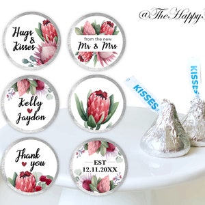 May include: Set of 6 round wedding favor stickers with watercolor pink protea flowers and greenery. The stickers feature text such as "Hugs & Kisses", "Kelly & Jaydon", "Thank you", "from the new Mr & Mrs", and "EST 12.11.20XX".