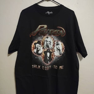 May include: Black t-shirt with a graphic of the band Poison. The graphic features the band members' faces in a circle with the band's name and the phrase "Talk Dirty To Me".