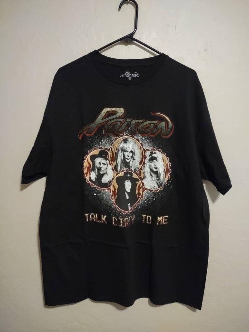 May include: Black t-shirt with a graphic of the band Poison. The graphic features the band members' faces in a circle with the band's name and the phrase "Talk Dirty To Me".