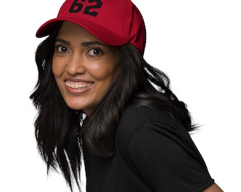 May include: A red baseball cap with a black number "62" embroidered on the front.