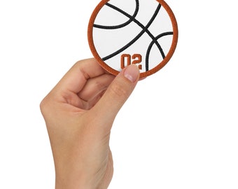 May include: A brown and white basketball patch with black stitching and the number "02" in orange.