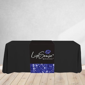 May include: Black table cover with a black and blue table runner. The table runner has a blue sequin design and the text "LipSense by SeneGence" in white.