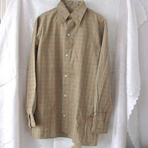 May include: A long-sleeved button-down shirt with a green and orange plaid pattern.