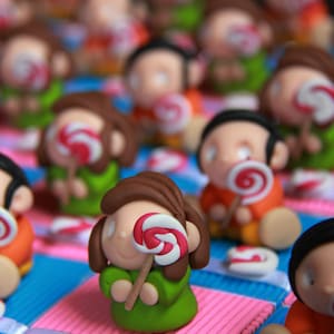 Children&#39;s dragees boxes and their sweets theme lollipops