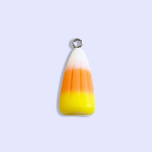 May include: A yellow, orange, and white candy corn charm with a silver loop at the top.