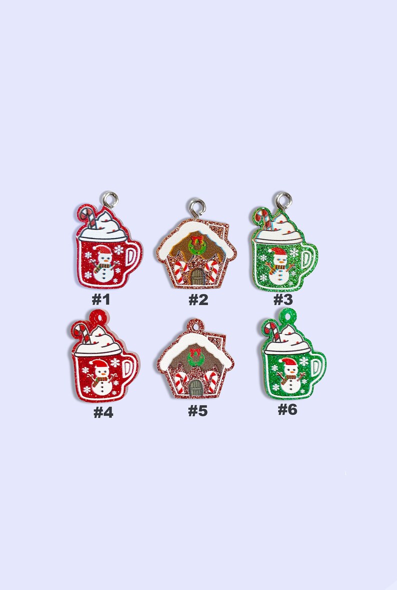 May include: Six Christmas ornaments, three are red mugs with white whipped cream and a snowman, and three are gingerbread houses with red and white candy canes. The ornaments are numbered 1 through 6.
