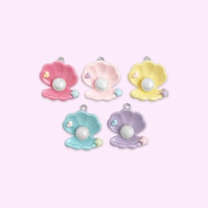 May include: Five colorful pearl clam charms with a pearl and a heart detail. The charms are pink, yellow, light blue, purple, and a darker shade of blue.