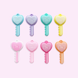 May include: Eight heart-shaped keychains in various pastel colors, each with the words "Pretty Girl" in a white square on the front.