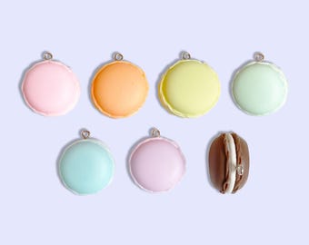 May include: A selection of colourful macaron charms in pastel shades of pink, orange, yellow, green, blue, and lavender, plus one chocolate-coloured macaron. Each charm has a silver loop for attaching to jewellery or other crafts.