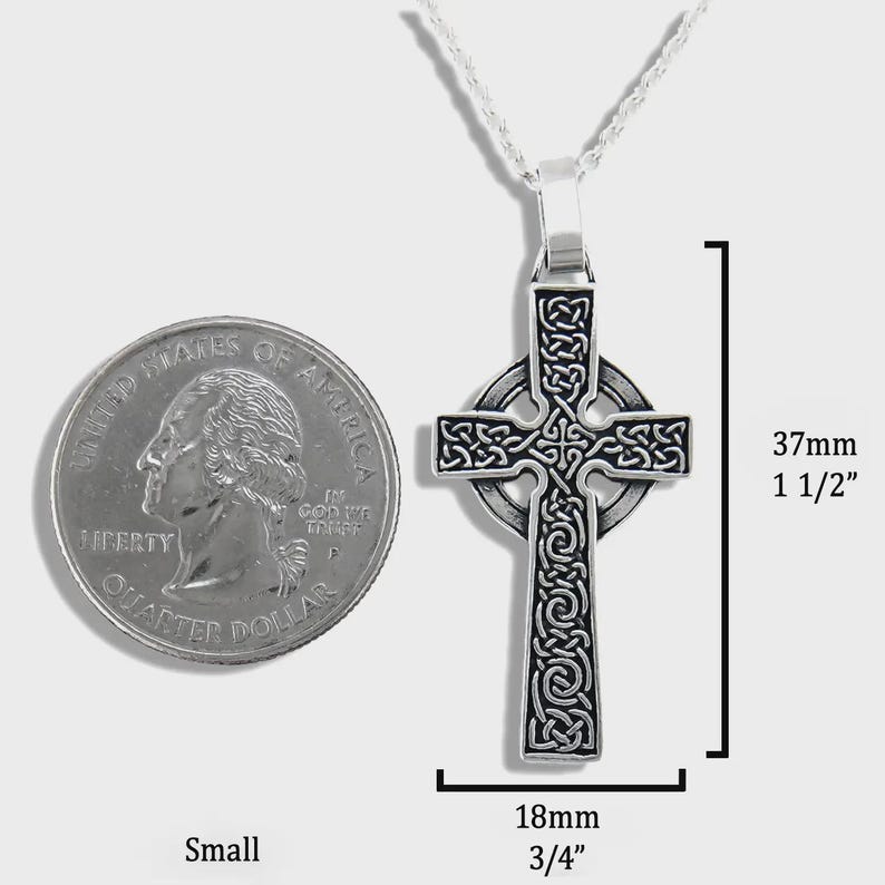 May include: A small, silver Celtic cross pendant on a chain. The cross is 3.7cm long and 1.8cm wide, with detailed knotwork. A U.S. quarter is next to the pendant for size comparison.