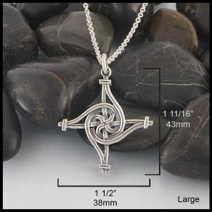 May include: Silver Celtic knot pendant necklace with a spiral design. The pendant measures 1 1/2 inches by 1 11/16 inches.