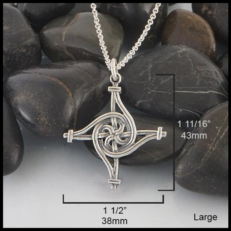 May include: Silver Celtic knot pendant necklace with a spiral design. The pendant measures 1 1/2 inches by 1 11/16 inches.