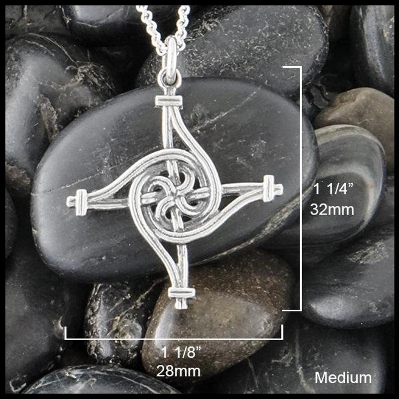May include: Silver Celtic knot pendant with a spiral design. The pendant measures 1 1/8 inches wide and 1 1/4 inches tall.