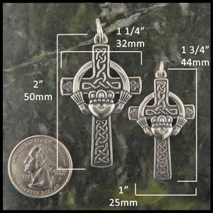 May include: Two silver Celtic cross pendants with a Claddagh design. The larger pendant measures 1 3/4 inches and the smaller pendant measures 1 1/4 inches. Both pendants are shown next to a US quarter for size comparison.
