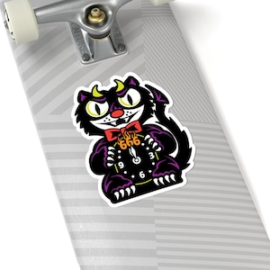 May include: A sticker featuring a cartoon black cat with yellow eyes, horns, and a devil tail. The cat is holding a clock with the number 666 on it. The cat is wearing a red bow tie and has purple accents.
