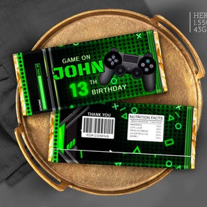 May include: Two Hershey's chocolate bars with a green and black video game theme. The top bar says "Game On John 13th Birthday" with a controller graphic. The bottom bar has a barcode and "Thank You".