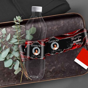 May include: Water bottle labels with a red, black, and silver design. The labels feature a photo of a person and the text "Hannah 20th Birthday" and "Thank You for Coming".
