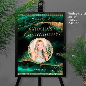 May include: A welcome sign for a Quincea&ntilde;era, featuring a portrait of a young woman. The sign has a dark emerald green and gold abstract design with the text "WELCOME TO NATOSHA'S Quincea&ntilde;era" and "APRIL 2026". Available in 8x10", 16x20", and 24x36" sizes.