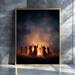 May include: A framed print featuring a dark, atmospheric scene of figures silhouetted against a bonfire. The artwork, with a gold frame, depicts a gathering with raised arms, illuminated by firelight and sparks. The artist's name, Celestiaq ART, is in the bottom corner.