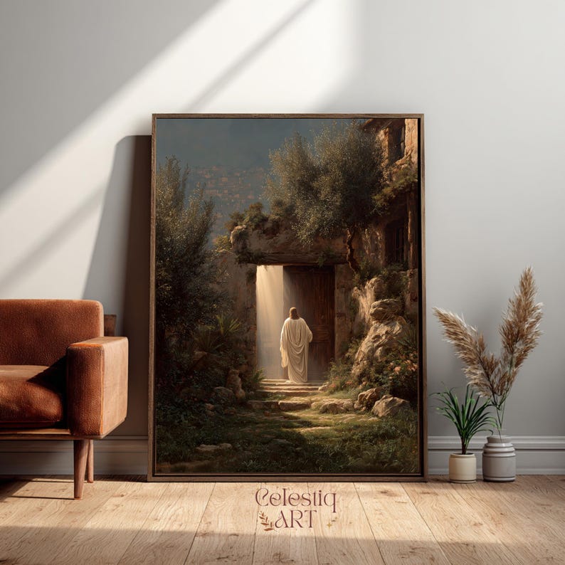 May include: Framed art print depicting a figure in white robes walking towards a bright doorway. The artwork features a detailed landscape with lush greenery, stone structures, and a warm, inviting light. The print is displayed in a brown frame.