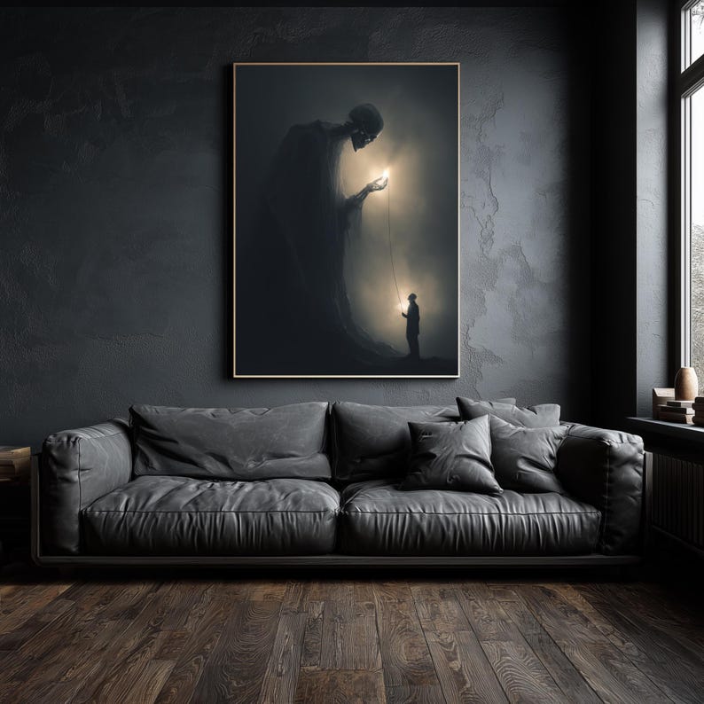 May include: A framed art print depicts a surreal scene with a large, shadowy figure holding a glowing orb connected to a smaller figure. The artwork is set against a dark, textured wall above a gray leather sofa.