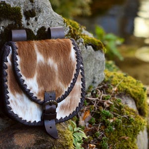 Medieval hair-on-leather belt bag with laced edges