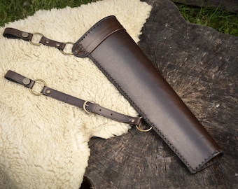 Leather side quiver with adjustable straps, hand-made with laced edges.