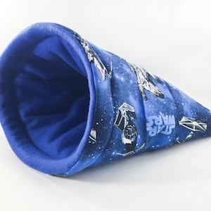 May include: A blue and white Star Wars themed cone-shaped pet bed. The bed is made of soft fabric and has a plush lining.