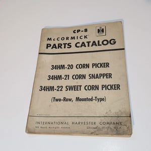May include: A vintage McCormick Parts Catalog for corn pickers. The cover features the text "CP-8" and "PARTS CATALOG" in bold, black letters. The catalog lists models 34HM-20, 34HM-21, and 34HM-22. The International Harvester Company is also listed.